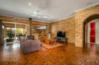 Parquetry floor & wood heater in living room