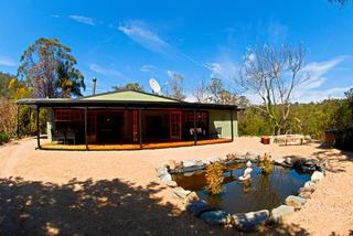 house front with pond