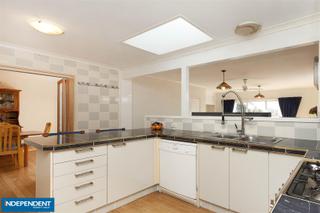 Fuctional kitchen design with breakfast bar and skylight